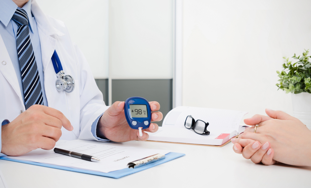 Adult checking blood sugar with glucose meter outdoors during hot summer day in Winter Haven, Florida