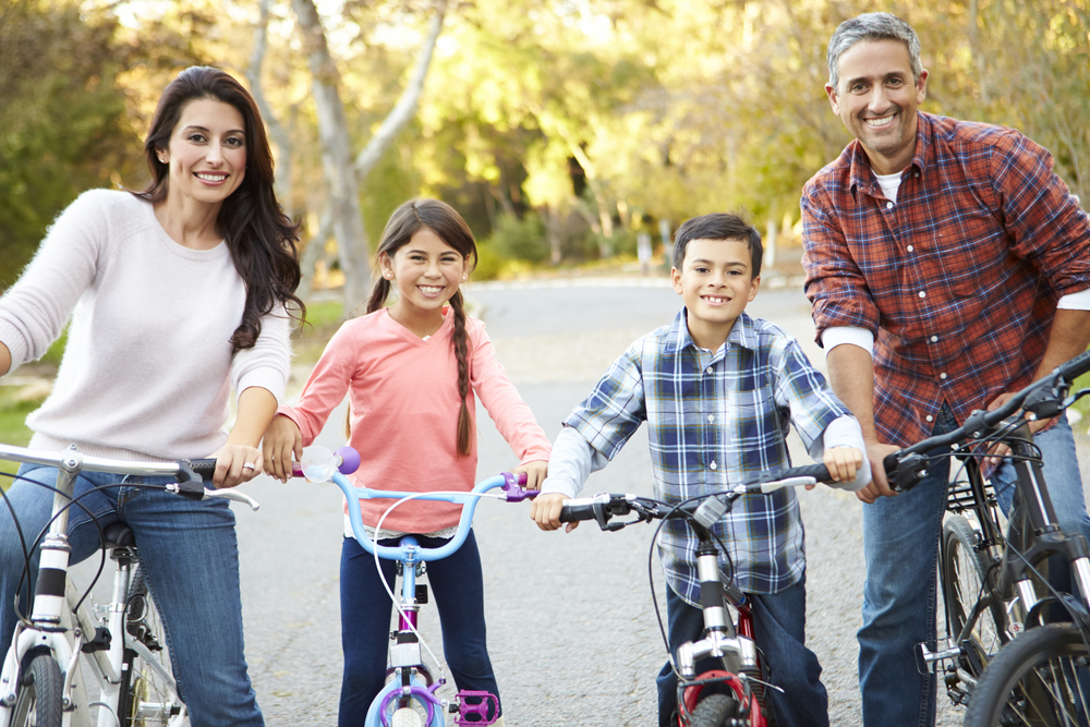 A family riding bikes on a trail.