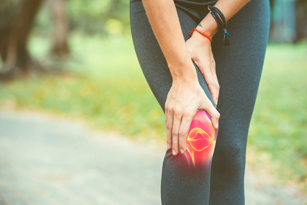 A person tending to a sore knee 