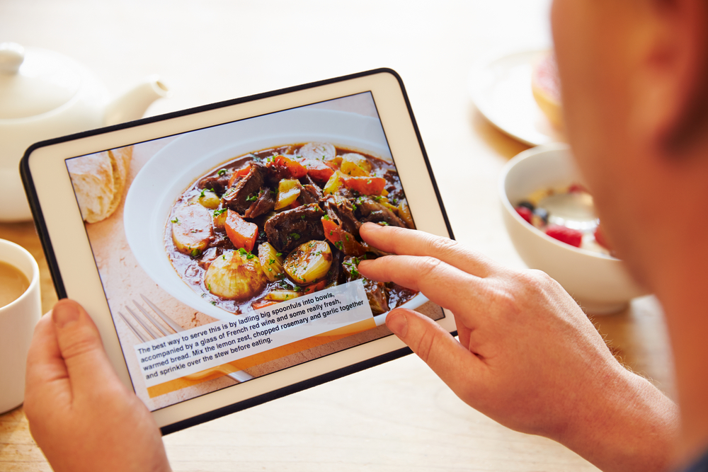 A person is looking at a recipe on a tablet